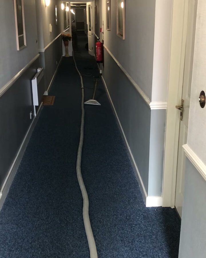 Peter's hose and wand running down a long carpeted corridor